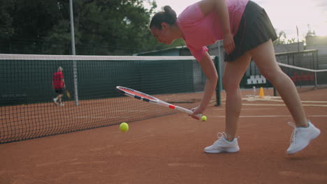 Attractive-Athlete-Poses-Near-Net-In-Tennis-Court.-Young-athletic-female-playing-tennis-walking-in-an-indoor-court-woman-player-become-on-a-game-position-training-day